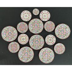 twelve decorative plates with colorful designs on them