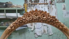 a wooden arch with flowers carved on it