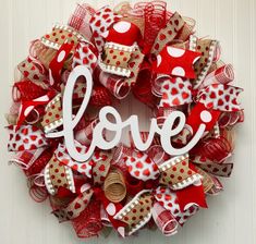 a red and white wreath with the word love on it