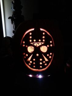 a pumpkin carved to look like a hockey wheel