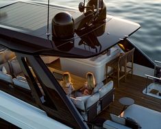 two women sitting on the back of a boat