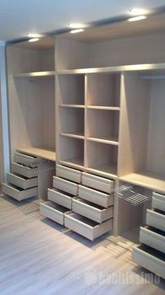 an empty room with some drawers and shelves