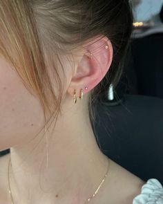 a close up of a person wearing some kind of earring on their left side