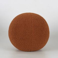 a brown ball sitting on top of a white floor