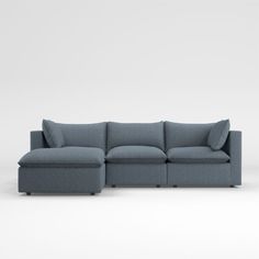 a blue sectional couch with pillows on the top and bottom, in front of a white background