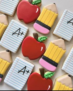 decorated cookies are arranged in the shape of school supplies