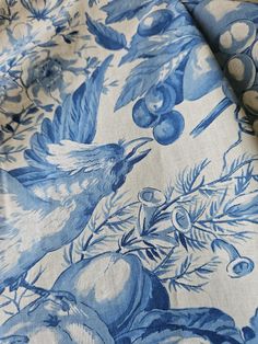 a blue and white fabric with birds on it