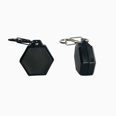 two black hexagonal keychains are shown with one attached to the other