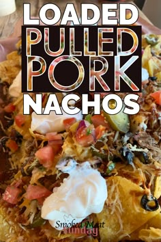 loaded pulled pork nachos with ranch dressing and sour cream in the middle on top