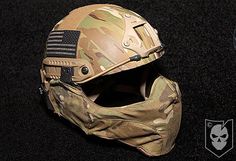 the helmet is camouflaged and has an american flag on it, as well as a skull