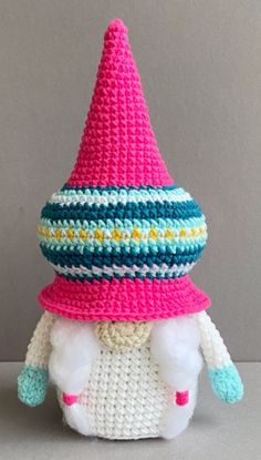 a crocheted stuffed animal wearing a pink and blue hat