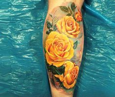 a yellow rose tattoo on the leg