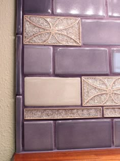 a close up view of a purple tile wall