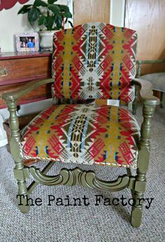 an old chair is upholstered with colorful fabric and has the words, the paint factory on it