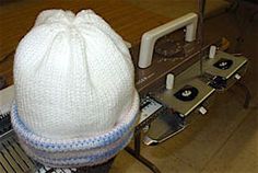 a white knitted beanie sitting on top of an old record player's turntable