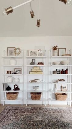 a living room filled with lots of white shelves