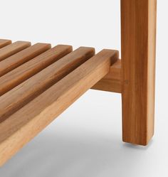 a close up of a wooden bench with slats