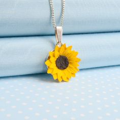 A bright, cheerful pendant necklace featuring the British summer garden favourite,this beautifully carved and painted Sunflower Pendant necklace brings out natures beauty. A perfect adornment to enhance many outfits and a wonderful gift to brighten the day. Designed, hand made in a resin mixture and carefully hand painted in fine quality acrylic pigments by the partners in their rural  Welsh studios.The pendant measures 23 mm (1 inch )  with a choice of 18 inch, 16 inch or 12 inch fine curb chai Clay Keychain, Sunflower Jewelry, Resin Stone, Sunflower Pendant, British Summer, Sunflower Necklace, Good Intentions, Jewelry Resin, Necklace Chain Lengths