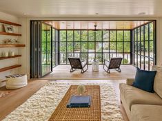 a living room filled with furniture and lots of windows