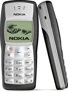 an old nokia cell phone sitting on top of a white surface