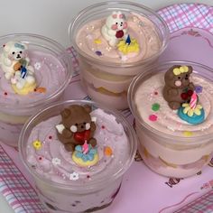 four plastic containers filled with cupcakes and teddy bears