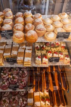 a display case filled with lots of different types of pastries