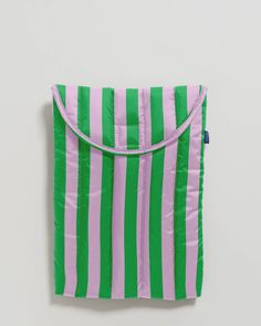 a green and pink striped bag hanging on the wall