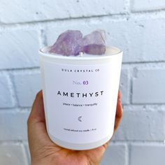 a person holding up a cup with amethyst on it