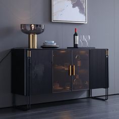 a black cabinet with two wine glasses on it