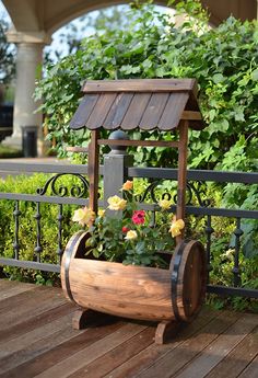 a wooden planter with flowers in it on a deck