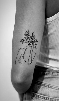 a woman with a flower tattoo on her arm