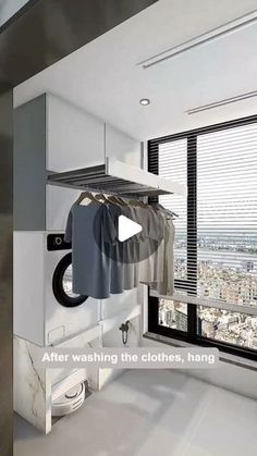 an image of a room with clothes hanging on the rack in front of a window