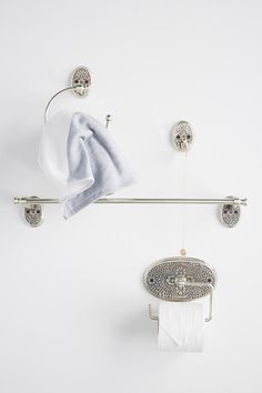 a towel rack with two rolls of toilet paper hanging from it's sides and one roll of tissue on the other side