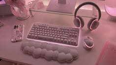 a computer desk with headphones and a keyboard