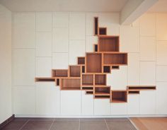 a wooden shelf sitting on top of a tiled floor