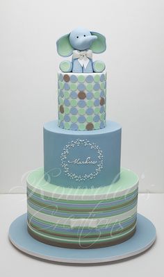 a three tiered cake with an elephant on top