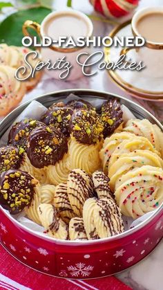 old - fashioned sprity cookies in a red tin on a white tablecloth