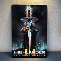 the poster for highlander ii is hanging on the wall next to a light switch