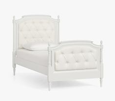 a white bed with tufted headboard and foot board is shown against a white background