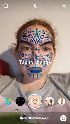 a girl with her face painted in blue and white, is looking at the camera