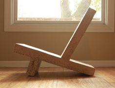 a wooden chair sitting in front of a window on top of a hard wood floor