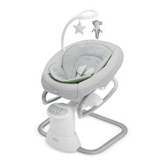 a baby's swing that is attached to the side of a white stand with stars on it