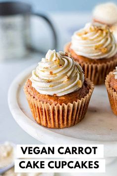 cupcakes with white frosting on a cake plate