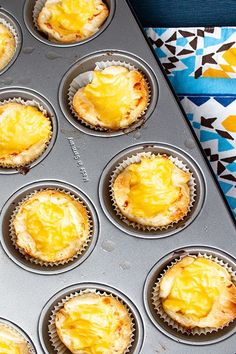 a muffin tin filled with yellow cupcakes