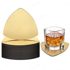 a set of four coasters with a glass on top