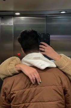 a person taking a selfie in an elevator