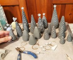 someone is making christmas trees out of clay and pliers on a table with other items