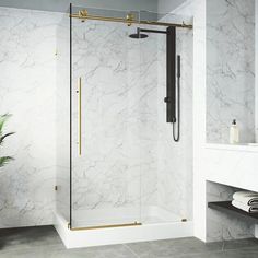 a bathroom with marble walls and flooring, including a walk - in shower stall