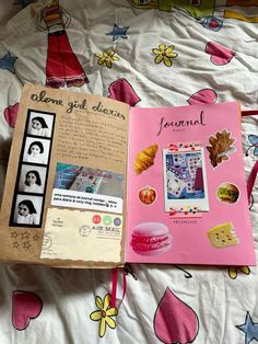 an open book sitting on top of a bed covered in pink sheets and colorful decorations