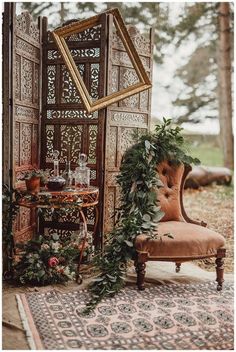 an antique chair and table with greenery on it